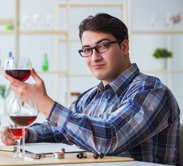 Professional sommelier tasting red wine
