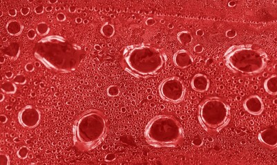 Ice cold red glass with water drops