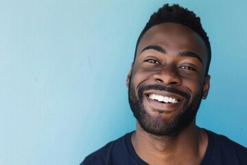 Obraz premium A charming man, his casual attire and vibrant, carefree smile suggest a welcoming and optimistic personality..