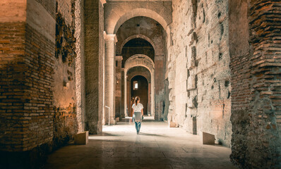 Fototapeta na wymiar Wanderlust Travelling Girl walking in Roman Colosseum and Forum in Rome, Italy