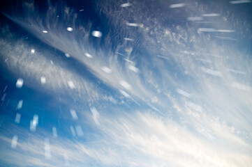 Blue cloudy sky with clouds unusual shapes.