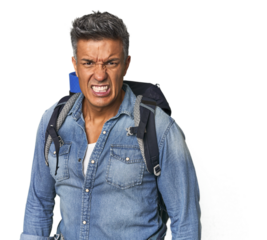 Hispanic hiker with backpack and flask screaming very angry and aggressive.