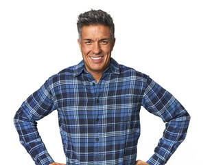 Middle-aged Latino man confident keeping hands on hips.