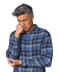 Obraz premium Middle-aged Latino man who feels sad and pensive, looking at copy space.