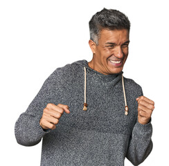 Middle-aged Latino man dancing and having fun.