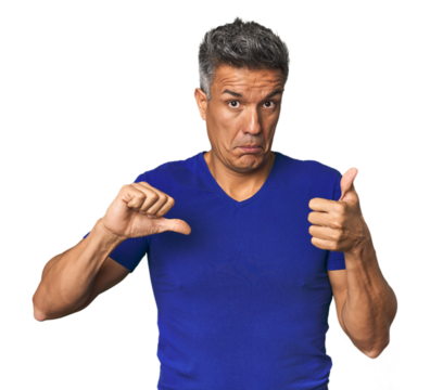 Middle-aged Latino man showing thumbs up and thumbs down, difficult choose concept