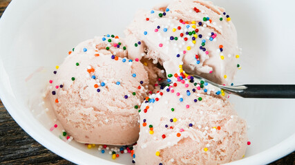 Close  up from ice cream in bowl with colorful sprinkles and copy space