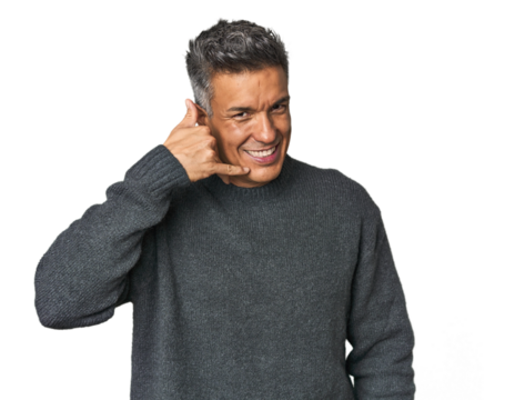 Middle-aged Latino man showing a mobile phone call gesture with fingers.