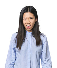 Young Chinese woman in blue shirt screaming very angry and aggressive.