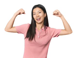 Young Chinese woman in studio setting showing strength gesture with arms, symbol of feminine power