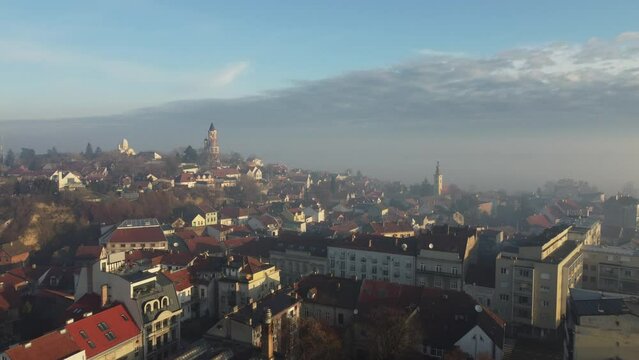 Drone flight above the church in the smog and fog in the morning. Zemun and New Belgrade district, Belgrade, Serbia, Europe.