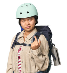 Chinese woman geared up for mountain activities pointing with finger at you as if inviting come closer.