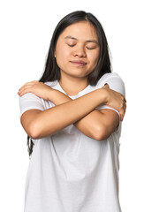 Young chinese woman isolated hugs, smiling carefree and happy.