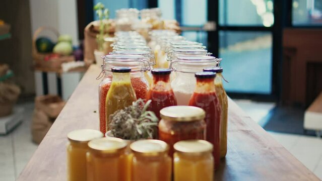 Chemicals free pasta and cooking relish in zero waste eco shop. Organic homegrown farming produce and pantry supplies sold in recyclable packaging, sustainable lifestyle grocery store. Handheld shot.
