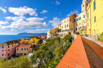 A terrace overlooks the blue Mediterranean Sea and town at the hilltop medieval town of Cervo,...