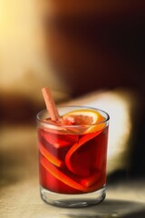 glass with hot mulled wine with cinnamon for the drink