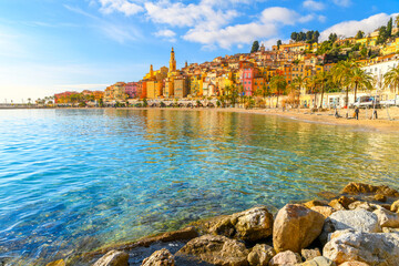 Townscape of the picturesque and colorful old town and Les Sablettes Beach and promenade along the...