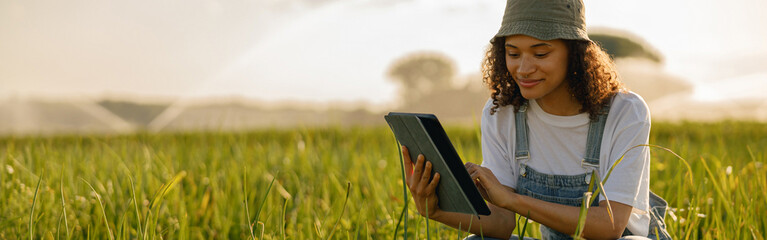 Professional woman agronomist with digital tablet works in field. High quality photo