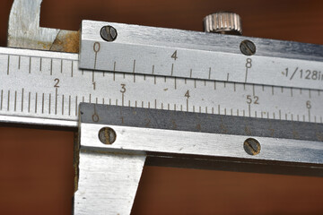 Caliper for precision measuring graduated in fractional inches and millimeters