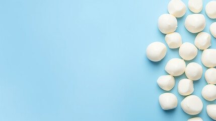 Mozzarella cheese balls on light blue background, top view	