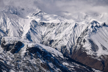 Obraz premium Stunning view of the Alps at the Meribel ski area in France. Sunny winter day, blue sky, clouds and peaks.