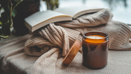 Burning candle in a cozy home interior