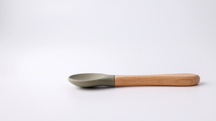 Silicone spoon for first feeding on a white background, side view