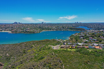 Fototapeta na wymiar High angle aerial drone view of Edwards Beach and Chinamans Beach in the suburb of Mosman, Sydney, New South Wales, Australia. North Sydney, Chatswood in the background, Grotto Point in foreground.