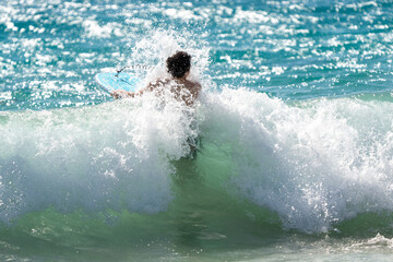 boogie boarding and playing in the water at Poipu beach