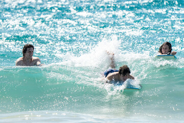 boogie boarding and playing in the water at Poipu beach