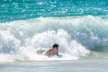 boogie boarding and playing in the water at Poipu beach