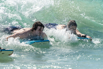 boogie boarding and playing in the water at Poipu beach