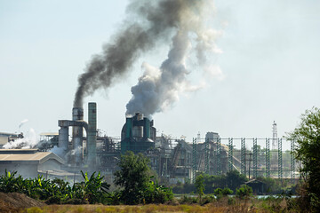 A metal factory emits smoke and smog which causes harmful environmental pollution. and destroy the ecosystem, photography captures this environmental impact.