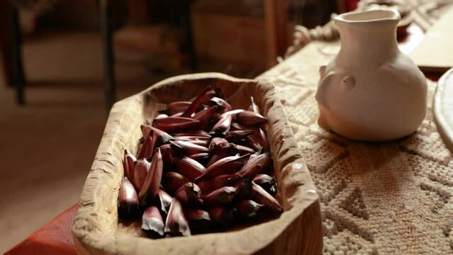 Culture and food. Mapuche sacred fruit. Closeup view of boiled Araucaria araucana fruits served in a wooden bowl.