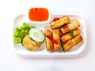 Deep fried spring rolls or “popia” in Malay, serve with hot sauce in white plate