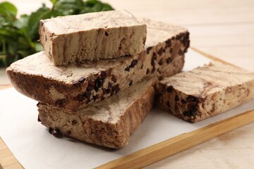 Pieces of tasty chocolate halva on table, closeup