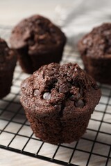 Delicious chocolate muffins on table, closeup view