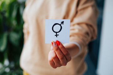 Photograph of incognito hands showing a message of equality.