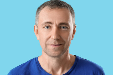 Portrait of handsome mature man on blue background