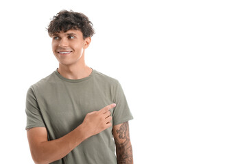 Portrait of handsome young man pointing at something isolated on white background