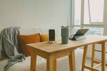 Minimal and loft living room design with iced-coffee and computer in concept of working space in evening.