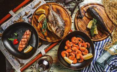 Seafood, grilled dorado fish, grilled salmon steak, smoked mackerel fish and fried shrimps with...