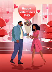 man giving bouquet of flowers to beautiful woman happy valentines day celebration concept air balloons in heart shape