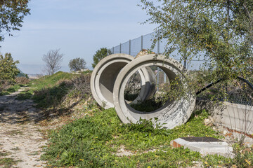 Large cement pipes abandoned in the middle of the field