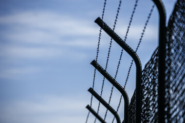 A separator fence in a field with anti-trespass spikes