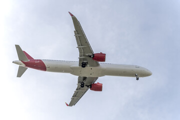 Fuselage of a passenger plane in a beautiful blue sky going down