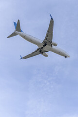 Views of the fuselage of a passenger plane approaching an airport runway
