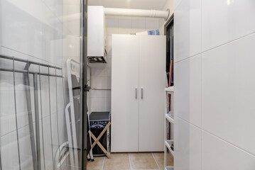 A storage room with a white wardrobe
