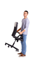 Young man carrying office chair on white background