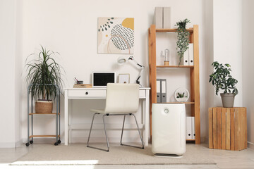 Interior of modern office with air purifier and workplace - obrazy, fototapety, plakaty